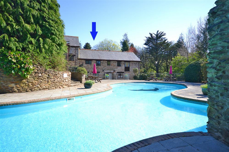 Colmer outdoor swimming pool with Gatehouse East arrowed