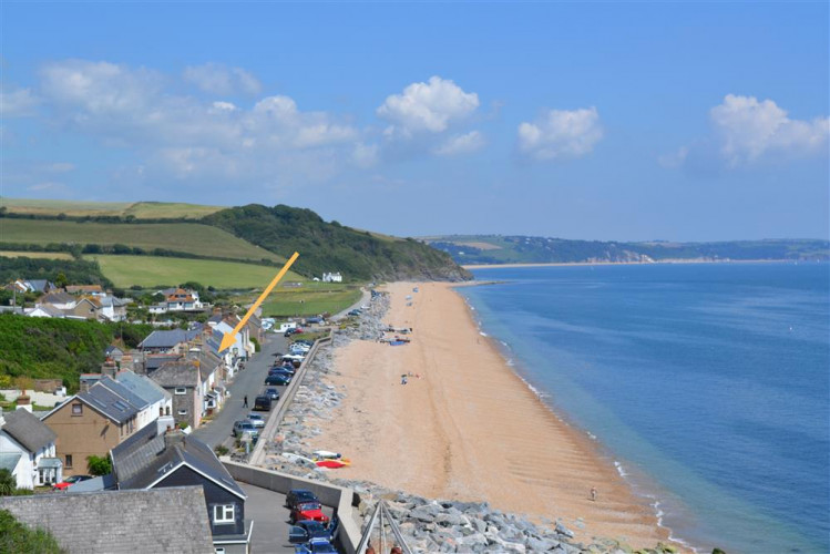 Beesands from the coastal path with the cottage arrowed. Since this photo storms have moved the beach towards the other end of the village.
