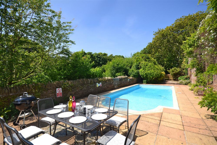 The solar heated swimming pool with quality outdoor table and chairs and Weber barbecue